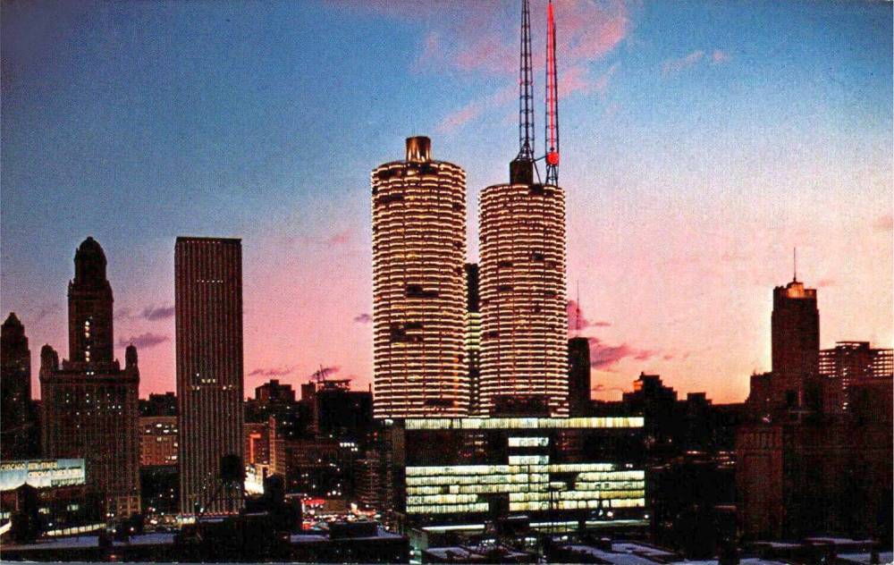 POSTCARD - CHICAGO - PORTION OF SKYLINE - FEATURING MARINA CITY WITH CHRISTMAS LIGHTS - LOOKING S - FROM N OF CHICAGO RIVER - TWILIGHT - c1965
